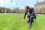 Richard Holden MP planting remembrance cross
